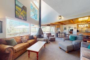 a living room with a couch and a table at Bass Lake Lodge in Bass Lake