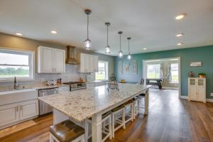 a kitchen with a large island in the middle at Charming Cadillac Retreat with Private Hot Tub! in Cadillac