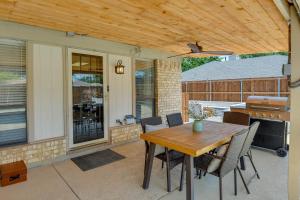 a patio with a table and chairs and a grill at Chic Lewisville Getaway with Private Pool and Hot Tub! in Lewisville