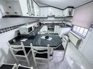 a small kitchen with a table with a microwave at Casa Gonzalo in Arou