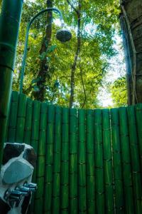 a green fence with a light on top of it at La Fortuna Natural Green in Fortuna