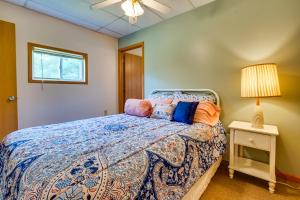 a bedroom with a bed and a lamp and a window at Quaint Somerset Getaway with Fire Pit! in Mount Perry