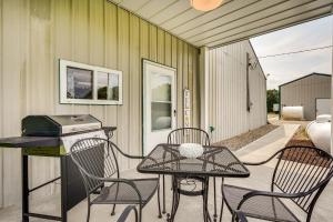 a patio with a table and chairs and a grill at Quaint Somerset Getaway with Fire Pit! in Mount Perry