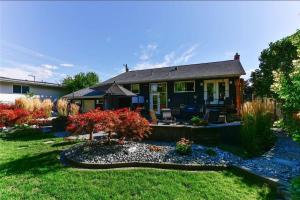 une maison avec une cour et un étang dans l'établissement Serene Waterfront Escape with Pool, Hot Tub, Pet-Friendly Haven, & Breathtaking Views, à Kelowna