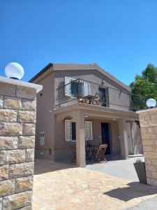a large house with a balcony and a patio at Apartments Hvaranin in Stari Grad +10 photos