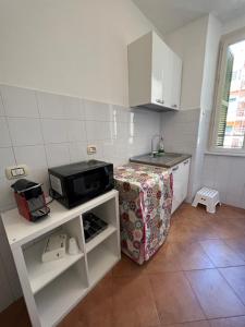 a small kitchen with a sink and a microwave at Podesti 6 in Rome