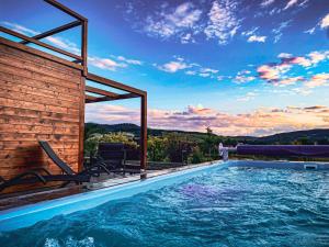 a swimming pool in a house with a view of the mountains at Dom Pod Przełęczą in Krynica Zdrój