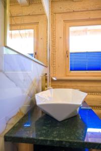 a white bowl on a counter in a bathroom at Beskid Wood Houses in Jasnowice