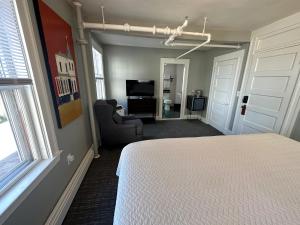 a bedroom with a bed and a living room at Gifford House in Provincetown