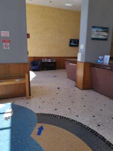 uma sala de espera vazia com setas azuis no chão em Estrela do Mar II em Portimão