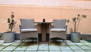 a table with two chairs and a vase on it at Zeiss house in Braşov +17 photos