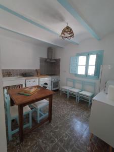 een keuken met een tafel en stoelen in een kamer bij La casa de tío Vidal in Pedro Bernardo