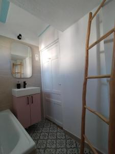 a bathroom with a ladder and a sink and a mirror at La casa de tío Vidal in Pedro Bernardo