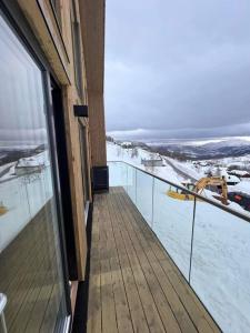 a balcony of a building with snow on the ground at Rindabotn Fjelltun in Sogndal