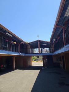 a large building with a balcony on top of it at Nights Inn Motel in Oakland
