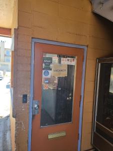 a door to a building with a warranty sign on it at Nights Inn Motel in Oakland