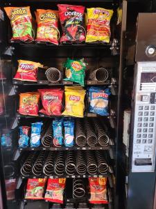 a refrigerator filled with lots of different types of chips at Nights Inn Motel in Oakland