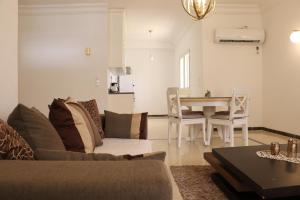 a living room with a couch and a table at Luxury house directly on the beach in Bizerte