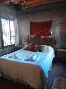 a bedroom with a large bed with towels on it at La Loica in Barreal +26 photos