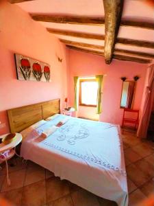 a bedroom with a large bed in a room with pink walls at The Four Angels in Massa