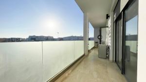 a balcony with white walls and a view of the city at Cosy Bay appartement 4 - 5px in Agadir
