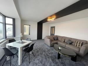 a living room with a couch and a table at Seaviews Apartment, Whitley Bay Sea Front in Whitley Bay