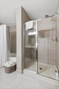 a bathroom with a glass shower with a toilet at Fully Furnished Apts at The Mag mile -Cloud9 - 747 in Chicago