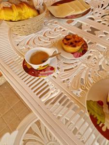 a table topped with a cup of coffee and pastries at Recanto da Serra - Alojamento Local in Lousã