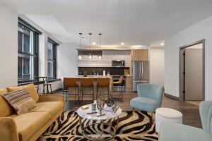 a living room and kitchen with a couch and a table at Fully Furnished Apt Near Millenium Park- 29 in Chicago