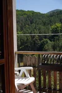 a pair of white chairs on a porch with a view at Roccaraso Love & Lodge - Mountain Chalet in Roccaraso