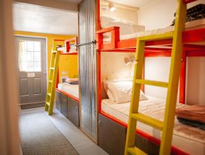 a room with two bunk beds and a ladder at Cloudcroft Hostel in Cloudcroft