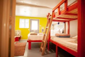 two bunk beds in a room with yellow walls at Cloudcroft Hostel in Cloudcroft