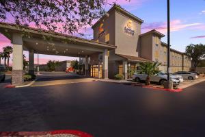 a hotel with a parking lot with cars parked at Comfort Inn & Suites Las Vegas - Nellis in Las Vegas