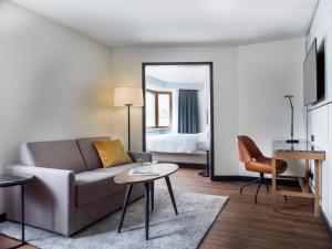 a living room with a couch and a table at Radisson Blu Royal Viking Hotel, Stockholm in Stockholm