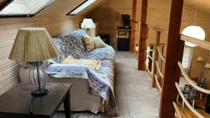 a room with a couch and a lamp in a cabin at Houseboat - Beacon of happiness in Jarovce