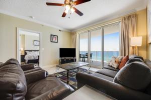 a living room with a couch and a television at PARKING INCLUDED-Beachfront 2BD Ocean Villa! Gorgeous Amenities, Private Complex in Panama City Beach