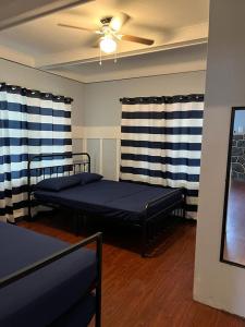 a bedroom with two beds and a ceiling fan at Blue Little Havana in Miami