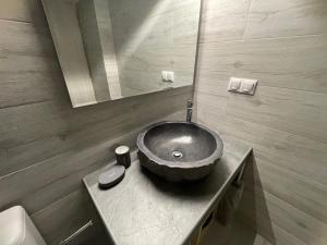 a bathroom with a bowl sink on a counter at Coco Luxury Apartments in Poros
