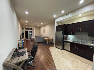a kitchen and living room with a table and chairs at Stunning 2bd with new furniture in Irvine