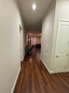 an empty room with a hallway with a table and chairs at Stunning 2bd with new furniture in Irvine