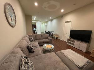 a living room with a couch and a flat screen tv at Stunning 2bd with new furniture in Irvine