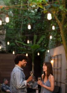 a man and a woman holding glasses of wine at Park Lane Suites & Inn in Portland