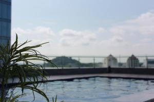 a swimming pool on the roof of a building at Galeno Pollux Habibie in Batam Center