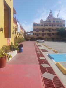 a street with a building and a parking lot at HOTEL SEVILLA in Tijuana