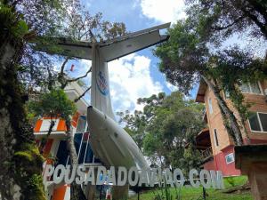 a plane is sitting outside of a building at Vivie Pousada in Monte Verde