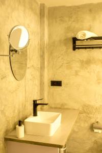 a bathroom with a sink and a mirror at Silver County Hotel, Fuvahmulah - Maldives in Fuvahmulah