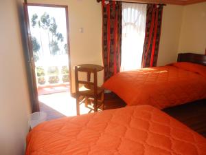 a bedroom with a bed and a door to a patio at Hostal del Sol Isla del Sol in Isla de Sol