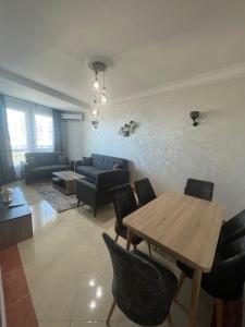 a living room with a table and a couch at Playa malabata in Tangier +26 photos