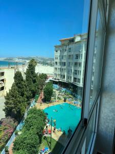 a view of a swimming pool from a hotel window at Playa malabata in Tangier