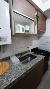 a kitchen with a sink and a counter top at Dpto en Complejo Ciudad Gama in Cordoba